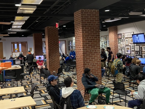 People playing video games in the Hawkeye Room in the IMU