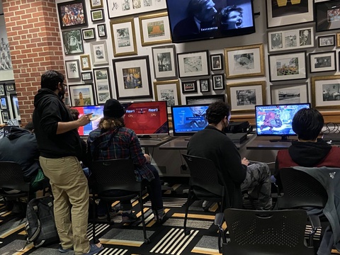 People playing video games in the Hawkeye Room in the IMU