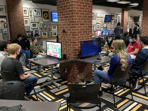 People playing video games in the Hawkeye Room in the IMU