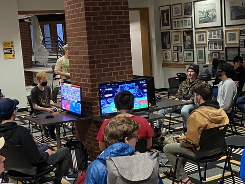 People playing video games in the Hawkeye Room in the IMU